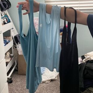 3 workout tops. Two Nike blue and black. One north face.